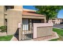 Charming condo exterior shows front entrance, private gate and brick trim at 1432 W Emerald Ave # 712, Mesa, AZ 85202