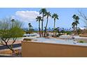 View of neighborhood with lush palm trees and a clear blue sky with some clouds at 14620 N Yerba Buena Way # D, Fountain Hills, AZ 85268