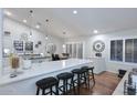 Modern kitchen with white cabinets, a kitchen island, bar stool seating, and recessed lighting at 15273 N 92Nd Pl, Scottsdale, AZ 85260