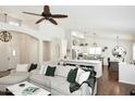 Spacious living room boasts soaring ceilings, a ceiling fan, and a view to the bright and modern kitchen at 15273 N 92Nd Pl, Scottsdale, AZ 85260