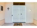 Close-up of the secured front door and porch with a charming exterior light fixture at 15840 W Falcon Ridge Dr, Sun City West, AZ 85375