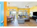 Comfortable living room featuring a cozy seating area with bright yellow walls and tile flooring at 15840 W Falcon Ridge Dr, Sun City West, AZ 85375