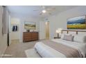 Comfortable bedroom featuring a ceiling fan, closet, carpeted floors, and natural light at 17031 E Calle Del Oro -- # B, Fountain Hills, AZ 85268