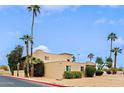 Stylish two-story townhouse featuring desert landscaping, mature palm trees, and private front patios at 17056 E Calle Del Oro Dr # B, Fountain Hills, AZ 85268