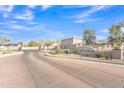 Community entrance with landscaping and the sign 'Las Colinas' on a clear, sunny day at 1715 E Branham Ln, Phoenix, AZ 85042