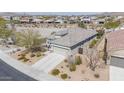 An aerial view shows the roof, desert landscaping, and privacy fencing of this single-Gathering home at 17796 W Sandy Rd, Goodyear, AZ 85338