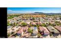 Aerial view of a vibrant community with well-maintained homes and stunning mountain views at 1869 E Birch St, Casa Grande, AZ 85122