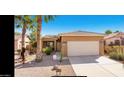 Charming single-story home featuring desert landscaping, a two-car garage, and palm trees at 1869 E Birch St, Casa Grande, AZ 85122