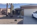 Inviting single-story home with desert landscaping, a two-car garage, and clear blue skies at 1869 E Birch St, Casa Grande, AZ 85122