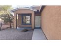 A charming covered front porch with a security door and desert landscaping at 1869 E Birch St, Casa Grande, AZ 85122