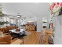 Bright living room featuring stylish decor, a ceiling fan, and seamless access to the outdoors via sliding glass doors at 1880 E Morten Ave # 124, Phoenix, AZ 85020