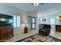 Inviting living room featuring neutral walls, tile floors, a ceiling fan, and sliding glass doors leading to the patio at 2101 S Meridian Rd # 190, Apache Junction, AZ 85120