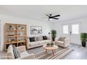 Bright living room featuring modern furnishings, striped rug, ceiling fan, and stylish decor at 2217 E Sheridan St, Phoenix, AZ 85006
