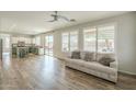 Inviting living room with open kitchen, hardwood floors, and plenty of natural light at 25622 N Singbush Loop, Phoenix, AZ 85083