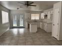 Eat in kitchen with island, white cabinets and stainless appliances at 2875 W Muriel Dr, Phoenix, AZ 85053