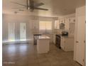 Eat in kitchen with island, white cabinets and stainless appliances at 2875 W Muriel Dr, Phoenix, AZ 85053