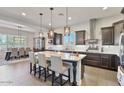 Bright, open kitchen with a granite island, pendant lighting, and modern appliances adjacent to the dining area at 2928 E Palm St, Mesa, AZ 85213