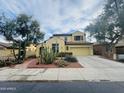 Two-story home with desert landscaping, a tile roof, and an attached two-car garage at 3325 E Grand Canyon Dr, Chandler, AZ 85249