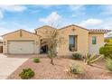 A beautifully landscaped single-story home with desert flora and a brick driveway under a bright sky at 3408 S 184Th Ln, Goodyear, AZ 85338