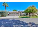 Charming home featuring a three-car garage, a tile roof, mature landscaping, and a well-maintained front yard at 4881 S Vista Pl, Chandler, AZ 85248