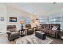 Inviting living room with plush seating, wood floors, and abundant natural light from large windows at 650 N Hawes Rd -- # 3217, Mesa, AZ 85207