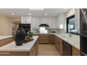 Bright kitchen featuring a mix of white and wooden cabinets, a modern sink, and stylish decor at 6802 N 22Nd Pl, Phoenix, AZ 85016