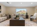 Relaxing living area featuring a comfortable sofa with mountain views through a large window at 6802 N 22Nd Pl, Phoenix, AZ 85016