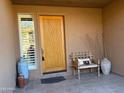 Inviting front porch with decorative bench and desert-themed accents by the front door at 10222 E Southwind Ln # 1054, Scottsdale, AZ 85262