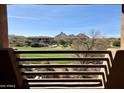 Balcony view of a lush green golf course with mountains in the distance at 10222 E Southwind Ln # 1054, Scottsdale, AZ 85262