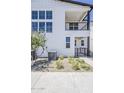 Elegant two-story home with a balcony, highlighted by meticulously arranged desert landscaping at 11300 N Casa Dega Dr # 1006, Surprise, AZ 85388