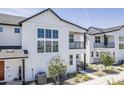Charming two-story home with a balcony, complemented by desert landscaping and modern design at 11300 N Casa Dega Dr # 1006, Surprise, AZ 85388