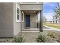 Close-up of a townhome entrance with a small porch and contemporary design elements at 11300 N Casa Dega Dr # 1020, Surprise, AZ 85388