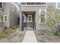 Inviting townhome entrance with small porch, metal gate, and manicured landscaping at 11300 N Casa Dega Dr # 1020, Surprise, AZ 85388