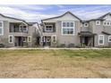 Charming townhome exterior with multiple levels, gray stucco, and a well-maintained lawn at 11300 N Casa Dega Dr # 1020, Surprise, AZ 85388