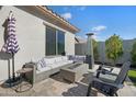 Back patio has a comfortable seating area with a fire pit and umbrella at 12047 E Sereno Rd, Gold Canyon, AZ 85118