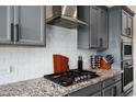 Gourmet kitchen features granite countertops, gray cabinets, stainless steel appliances, and subway tile backsplash at 12047 E Sereno Rd, Gold Canyon, AZ 85118