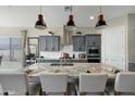 Large kitchen island with seating, granite countertops, stainless steel appliances, and pendant lighting at 12047 E Sereno Rd, Gold Canyon, AZ 85118