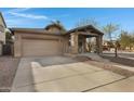 Beautiful single-story home with a cozy front porch, two-car garage, and low maintenance desert landscaping at 1473 W Flamingo Dr, Chandler, AZ 85286