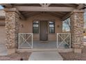 Up close view of the covered front porch featuring stone pillars and cozy seating area, enhancing curb appeal at 1473 W Flamingo Dr, Chandler, AZ 85286