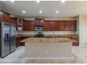 Large kitchen featuring granite countertops, a central island, and stainless steel appliances at 15290 W Ventura St, Surprise, AZ 85379