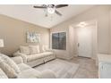 Bright living room with vaulted ceilings, tile flooring, plush seating and natural light at 16737 N 157Th Ave, Surprise, AZ 85374