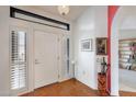 Bright foyer with tile flooring, white walls, and a view of a cozy reading nook and entryway at 19835 N Alta Loma Dr, Sun City West, AZ 85375