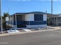 Charming mobile home featuring a screen room and white and blue color scheme at 205 S Higley Rd # 8, Mesa, AZ 85206