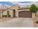 Inviting one-story house with a well-maintained yard, sheltered entryway, and an attached two-car garage at 229 E Alcatara Ave, Queen Creek, AZ 85140