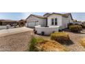 Home exterior featuring a landscaped front yard and a large three car garage at 24812 S Pleasant Ct, Sun Lakes, AZ 85248