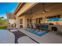 Covered patio features an outdoor dining area and provides a relaxing extension of the home's living space at 26991 N 97Th Ln, Peoria, AZ 85383