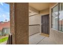 View of secure front door and charming welcome mat on balcony with wrought iron railing at 2929 W Yorkshire Dr # 2013, Phoenix, AZ 85027