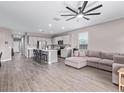 Open-concept living space with hardwood floors, recessed lighting, and a neutral color palette at 36708 N Petra Dr, San Tan Valley, AZ 85143