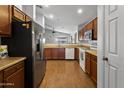 Kitchen with wood floors, stainless steel appliances, and bright lighting at 36765 W Mediterranean Way, Maricopa, AZ 85138