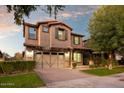 Charming two-story home featuring a paved driveway and a well-manicured lawn at 4084 E Rawhide St, Gilbert, AZ 85296